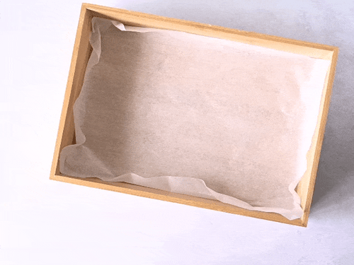 Rotating view of bamboo grazing box with clear lid being filled