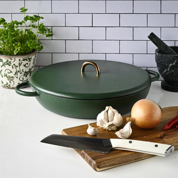 Thermomix® cast iron casserole dish with ingredients staged nearby