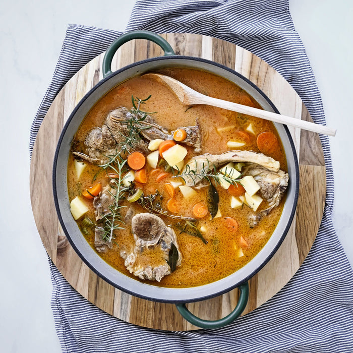 cast iron casserole dish with delicious chicken stew being served