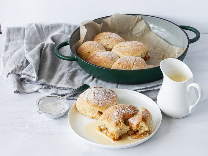 Side view of cast iron casserole dish with fresh bread pudding