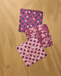 Geometry Mulberry Bloom Dot Dishcloth Set 3-pack flat lay on wood surface showing coordinating dot, floral bloom, and blush polka dot prints in mulberry pink tones